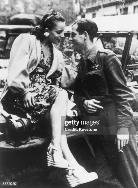 Young French woman makes eyes at an RAF officer after the liberation of Paris during World War II, 1944.