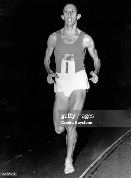 Australian middle-distance runner John Landy running a mile in 4 minutes 1.6 seconds at Stockholm Stadium, Sweden.
