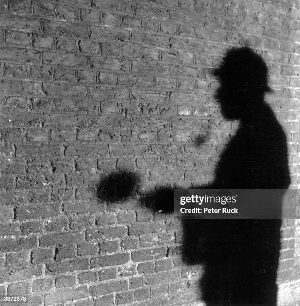 The shadow of R A Rendel, publicity manager for the Abbey National Building Society, in the guise of fictional detective Sherlock Holmes. Mr Rendel...