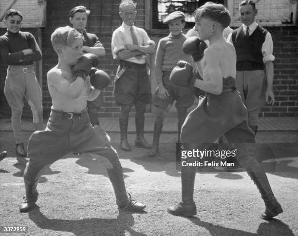 Stable boys at St Dunstan's in Epsom spend their spare time boxing. Original Publication: Picture Post - 141 - He Wants To Be A Jockey - pub.1939