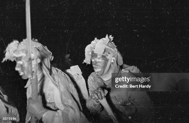 British troops paddling ashore during a night training exercise. Original Publication: Picture Post - 1415 - Night Operations - pub. 1943