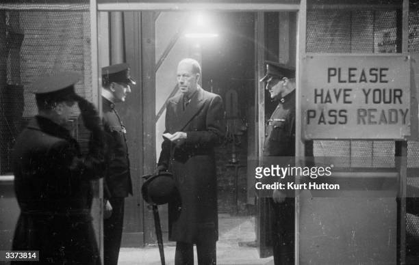 Director-General, Robert Foot showing his security pass at the entrance to Broadcasting House, London. Original Publication: Picture Post - 1332 -...