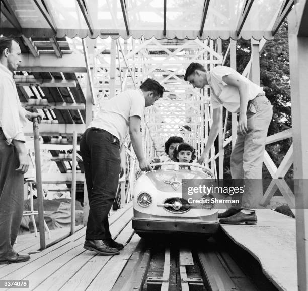 Employees of Palisades Amusement Park, New Jersey check the safety devices on each car before sending them on the Wild Mouse Ride.