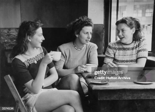 Three girls having a drink in a cafe.