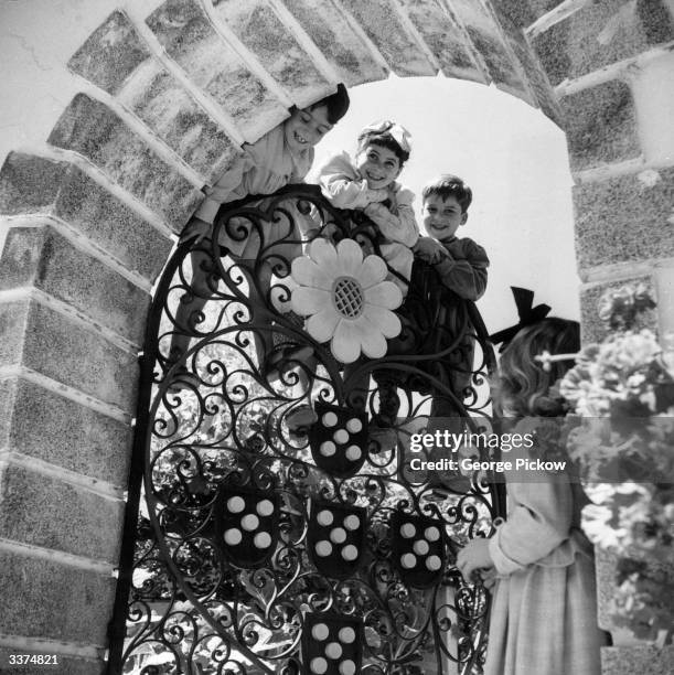 Children of Coimbra, near Lisbon, swing on a miniature replica gate in a uniquely constructed Day Home for the underprivileged. Founded by Dr Bissaya...