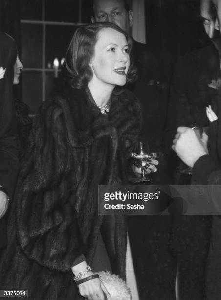 Lady Ashbey, wife of US actor Douglas Fairbanks Jnr, at a cocktail party at Queen Anne's Gate, London, hosted by Bobby Notham.