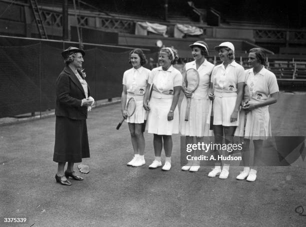 Hazel Wightman , former American tennis champion, founder of the Wightman Cup and captain of the US Wightman Cup team, chatting to the team on the...