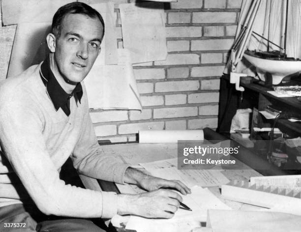 Jorn Utzon, architect of Sydney's Opera House, designing at his desk.