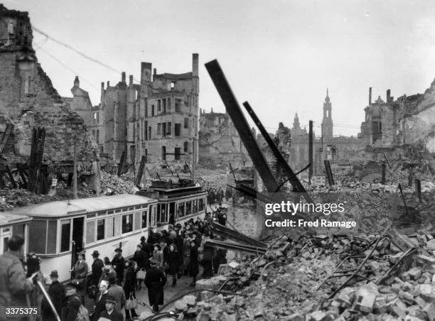 Bomb damaged Dresden, commuters boarding a tram.