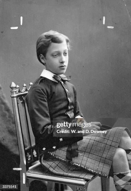 Prince Albert Victor , Duke of Clarence, son of Edward VII, seated wearing a kilt as a boy.