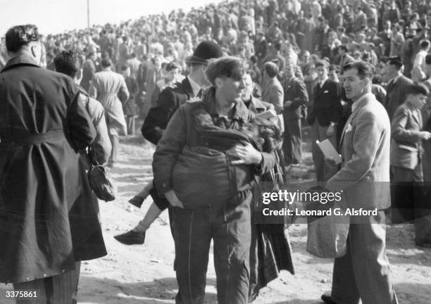 Child is carried away from the scene of the accident at the Farnborough Air Show, after a jet fighter crashed during a display, killing 27 people.