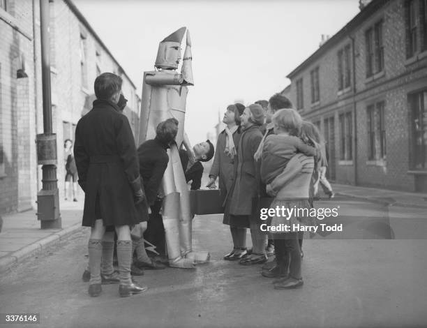 The children of Kettering in Northamptonshire stare in amazement at a walking talking robot, the invention of local electrical engineer Charles...