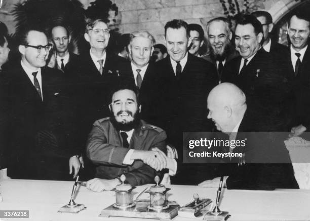 Fidel Castro, Cuban statesman and revolutionary shaking hands with Nikita Khrushchev after signing the Economic Treaty between Cuba and USSR.