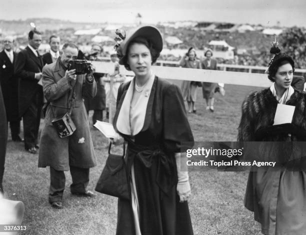 Princess Elizabeth, later Queen Elizabeth II of Great Britain, and Princess Margaret at the Epsom Racecourse during the Derby.