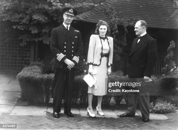 Pamela Churchill at the opening of the Derry rooftop Gardens in High Street Kensington, London with the General Manager of Derry and Toms department...