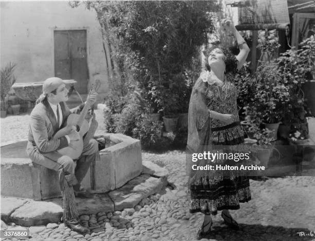 French actress Renee Adoree dances to the music of a Spanish guitar in a scene from the film 'The Bandolero', directed by Tom Terriss for MGM.