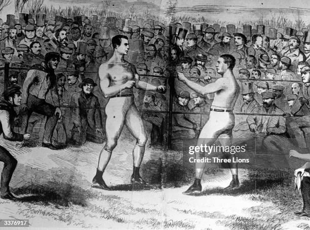 American boxer John C Heenan, left, and English boxer Tom Sayers fighting the first international boxing championship at an outdoor ring near...