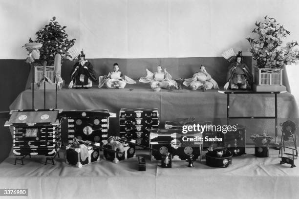 Japanese ceremonial dolls of the Emperor's ministers and various possessions including a royal palanquin and a royal cooking stove at the Japanese...