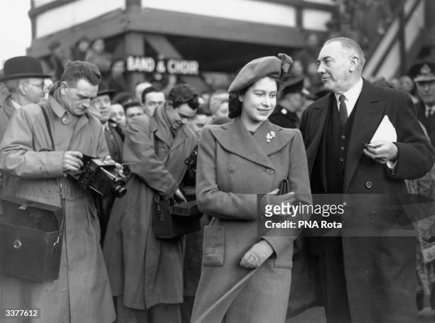 Princess Elizabeth, later Queen Elizabeth II of Great Britain, with Sir Frederick Rebbeck the managing director of Harland and Wolff, on the...