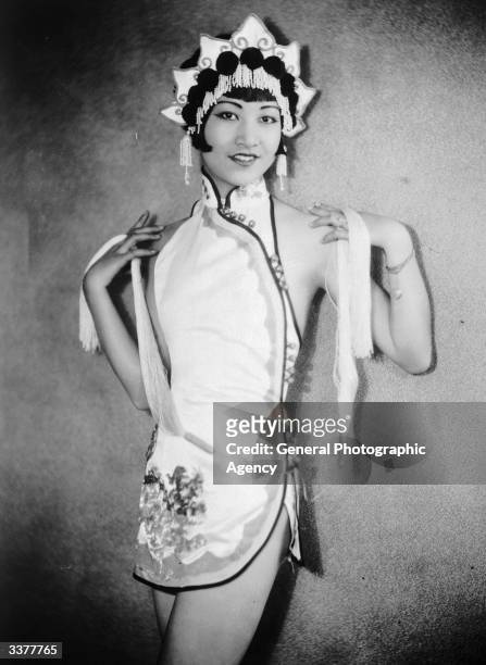 American-Chinese actress Anna May Wong wearing an Oriental-style costume and headdress.