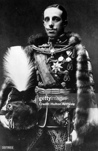 Alfonso XIII , king of Spain from 1886 to 1931, wearing ceremonial uniform and carrying a plumed hat.