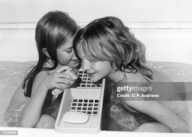 Two children sharing a bath.