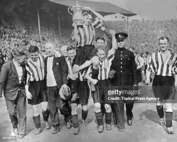 The players of Sunderland Football Club carry their captain, Raich Carter and the FA Cup shoulder high in celebration of their 3-1 victory over...