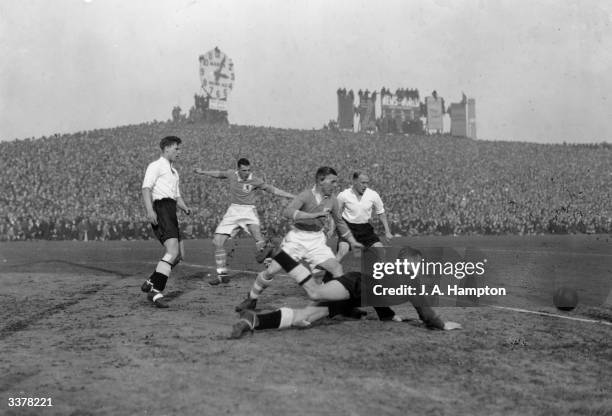 Derby County goalkeeper Scattergood makes a diving save, as Millwall FC play Derby County FC in an FA Cup tie at the Den, London, 20th February 1937.