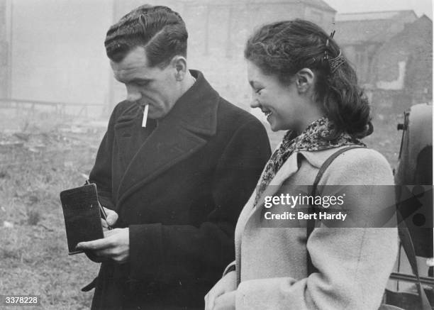 Harry Ferrier Portsmouth FC soccer player signing his autograph for a fan. Original Publication: Picture Post - 4679 - Pompey's Golden Jubilee - pub....