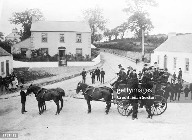 Passengers on an excursion from Belfast loading up a coach in the streets of Greyabbey, on the Ards Peninsula, County Down.