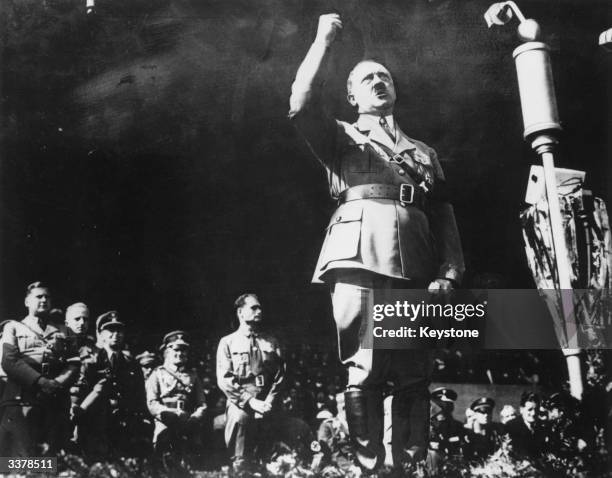 German dictator Adolf Hitler shaking his fist whilst addressing a crowd at a rally during the Second World War.