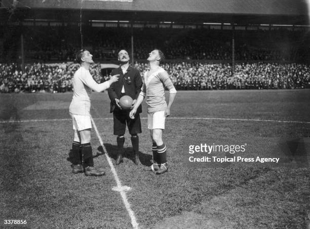 Captains toss the coin before the start of the match between Birmingham City and Chelsea.
