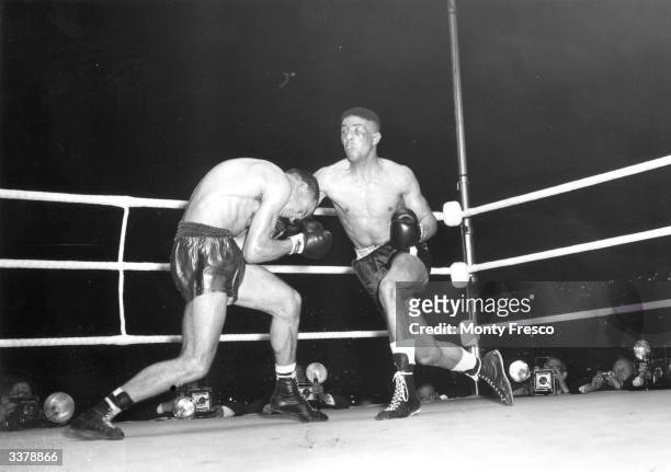 British boxer Randolph Turpin lands a right on Charles Humez of France on his way to beating him for the world middleweight title at White City...