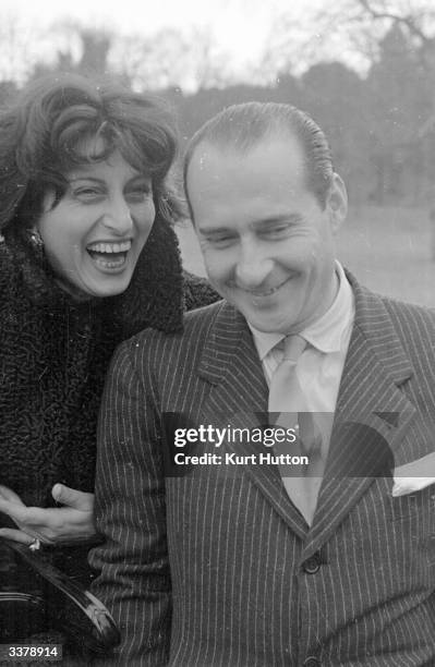 Italian screen actress Anna Magnani shares a joke with her lover, film director Roberto Rossellini . Original Publication: Picture Post - 4529 -...