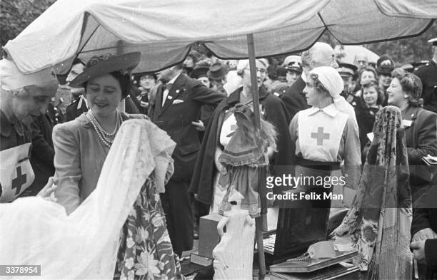 The Queen at a Russian stall during the Allied Nations' Summer Fair, held in the gardens of Clarence House, London. Original Publication: Picture...