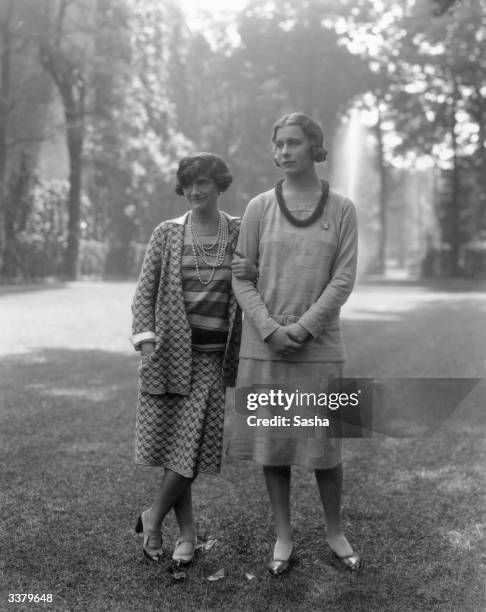 French couturier Coco Chanel, left, with Lady Abdy, in the garden of Chanel's Faubourg St Honore home, Paris.