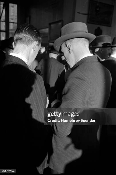 Two businessmen in a discussion at Newcastle's Commericial Exchange, Tyneside. Original Publication: Picture Post - 38 - Tyneside - pub. 1938