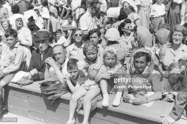 Section of the crowd watching the 1948 London Olympics in the summer heat at Wembley Stadium, London. Original Publication: Picture Post - 4582 -...