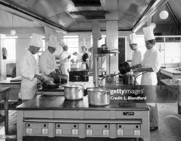 Students at work in a replica hotel kitchen, built in the training suite of a polytechnic college.