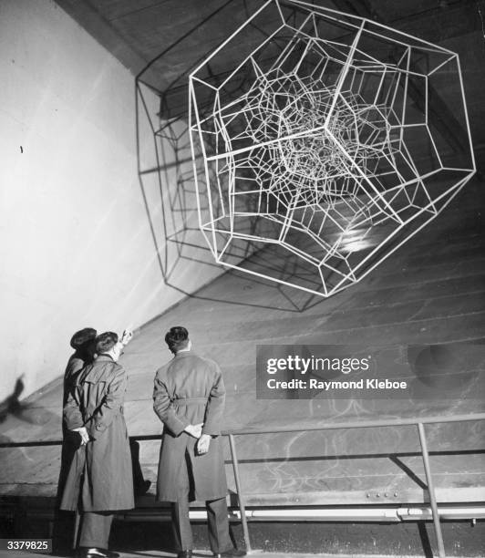 Group of schoolboys study a model depicting the structure of atoms in a crystal in the Dome of Discovery at the Festival of Britain, on London's...