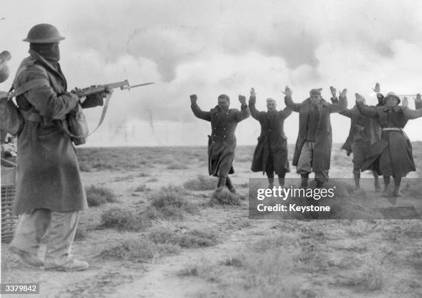 Italian soldiers surrender to an Australian soldier, near the Italian Libyan seaport of Bardi.