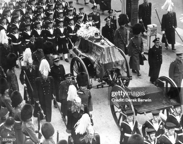 The coffin of King George VI lies on a gun carriage drawn by naval officers, and accompanied by men of the Household Cavalry. On top of the royal...