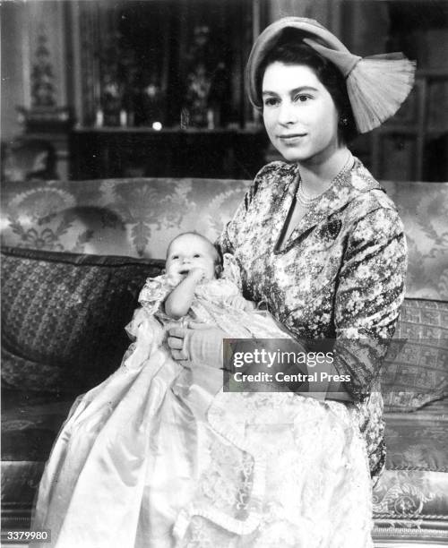 Princess Elizabeth with her baby daughter Princess Anne who is wearing the Royal christening robe made of Honiton lace.