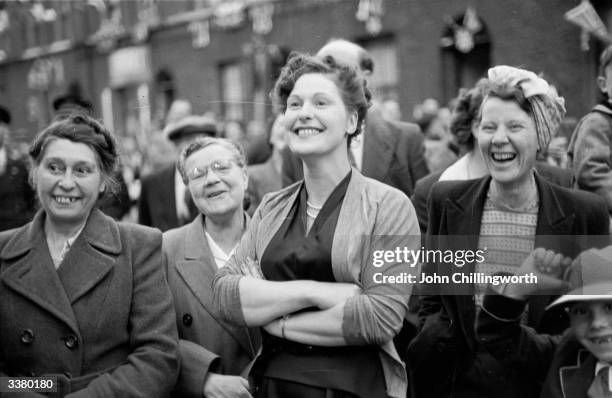 Residents of Morpeth Street in London's East End watching one of the entertainments put on to celebrate the coronation of Queen Elizabeth II....