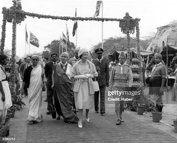 Queen Elizabeth II and Prince Philip Duke OF Edinburgh with officials from local girl guide and scout groups in India's capital Delhi.