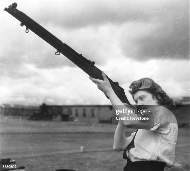 Officer examines a rifle during her training as an Armourer at a Scottish Royal Airforce Base.