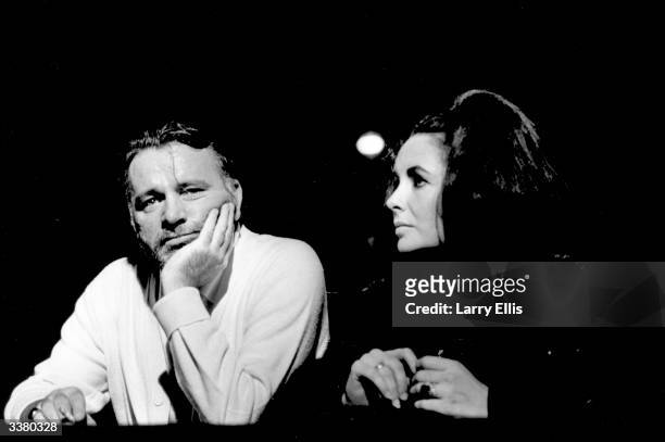 British actor Richard Burton attending a performance of 'Dr Faustus' with his wife actress Elizabeth Taylor.