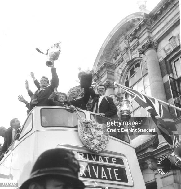 The players of Tottenham Hotspur Football Club wave the Division one championship and FA Cup trophies from an open top bus during a civic reception...