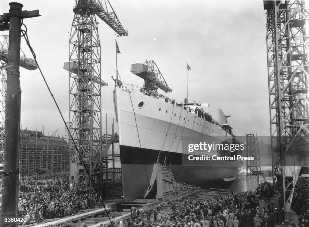 Crowds at the launch of HMS Belfast at the Harland and Wolff shipyard in Belfast.