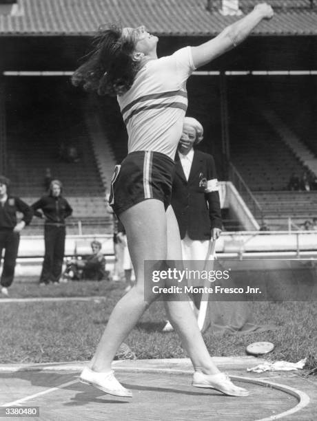 Suzanne Allday in action throwing the discus at the 29th Annual Women's Amateur Athletic Association Championships at White City Stadium, London.